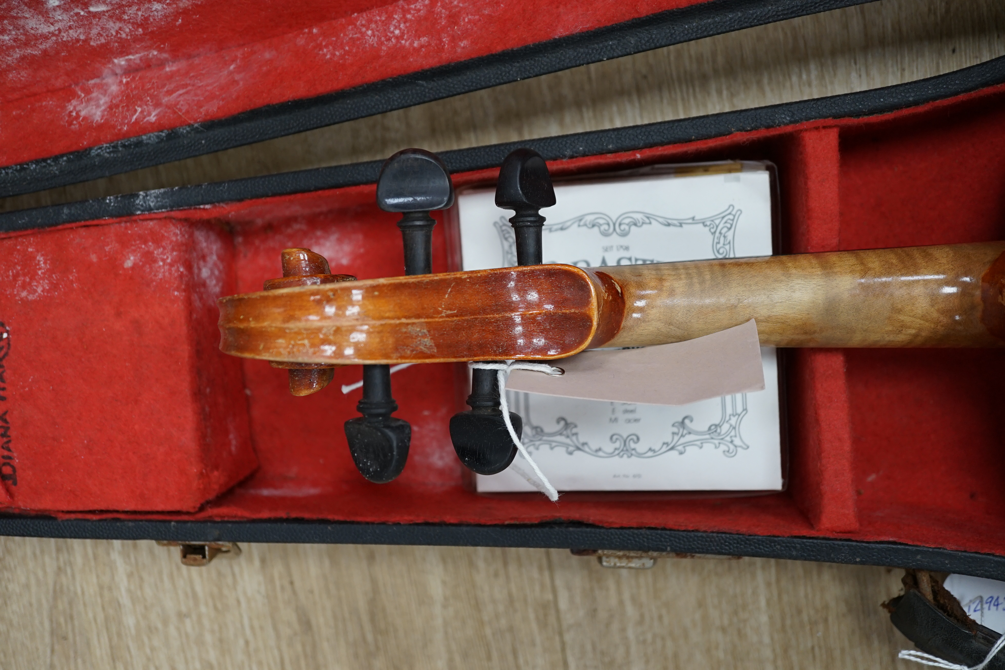 A cased Czechoslovakian student’s violin with Stradivarius label, length of body, 35.5cm, with spare strings